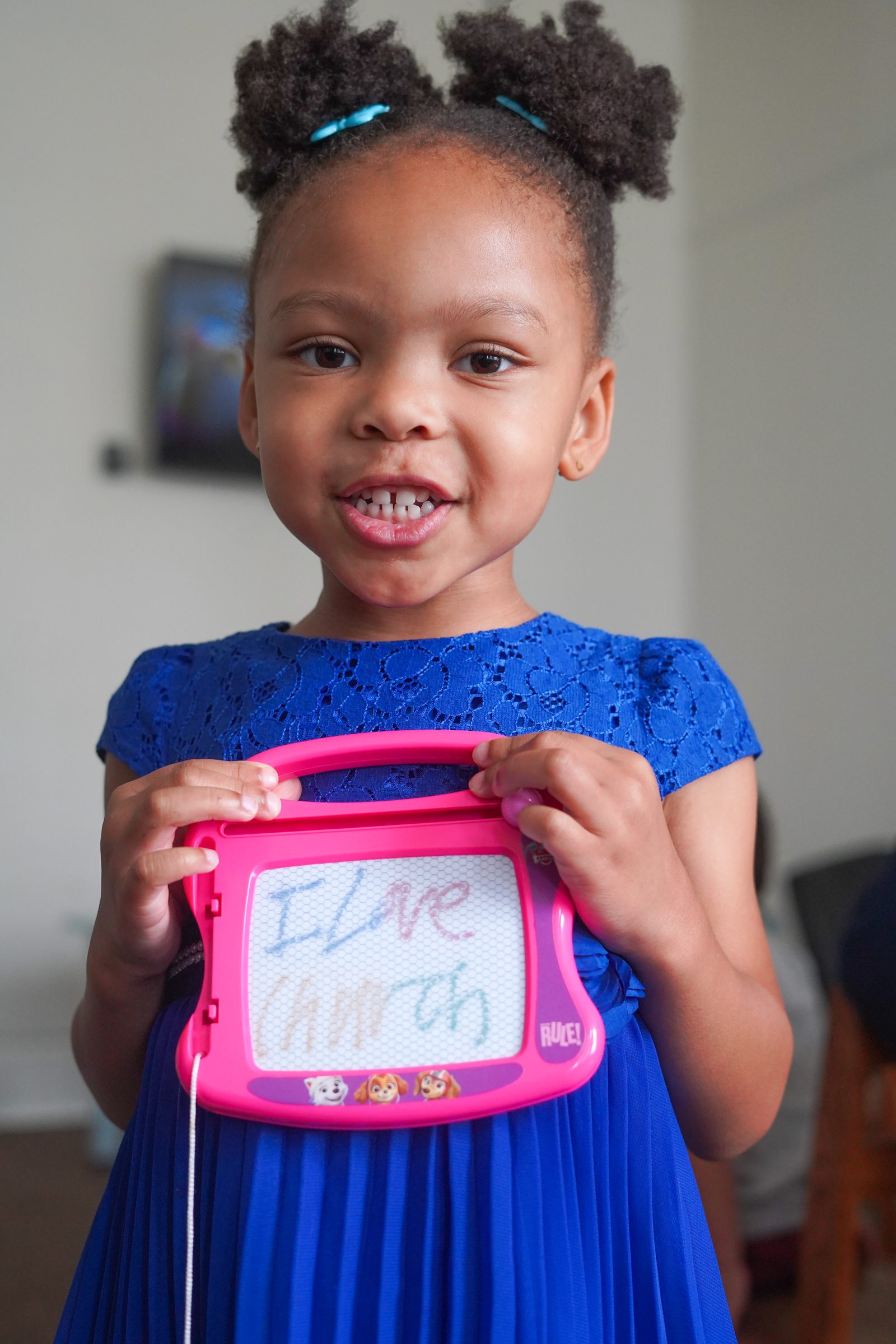 A Presence Kid proudly showing what she made